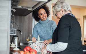 Senior Care Giver Cooking with Client