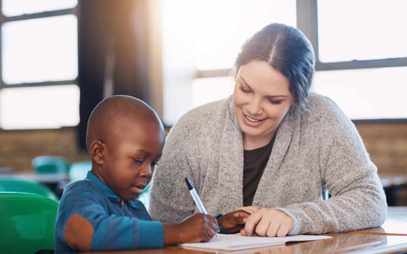 Child Tutor Working with Child